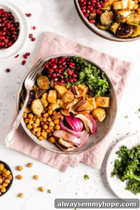 This vegan Buddha bowl is a flavor-packed meal brimming with caramelised roasted veggies, crispy chickpeas, tender baked tofu, and more! Overhead view of a vegan Buddha bowl filled with chickpeas, tofu, red onion, kale, and Brussels sprouts before dressing.