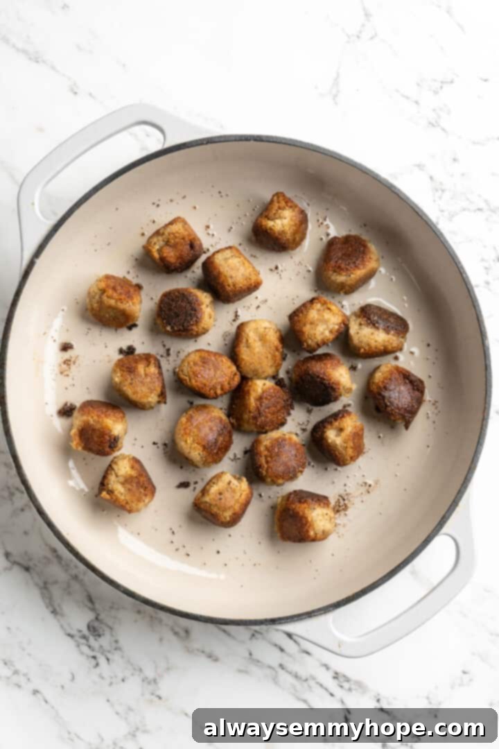 Overhead view of vegan meatballs seared in Dutch oven