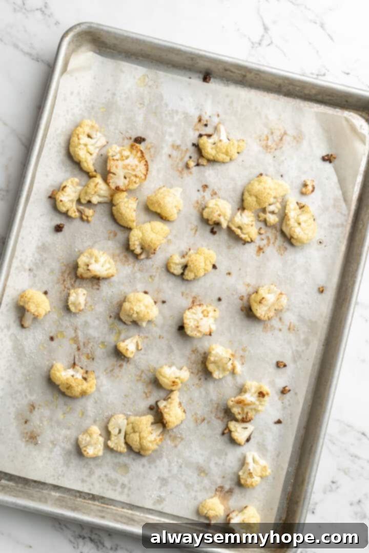Overhead view of roasted cauliflower on sheet pan