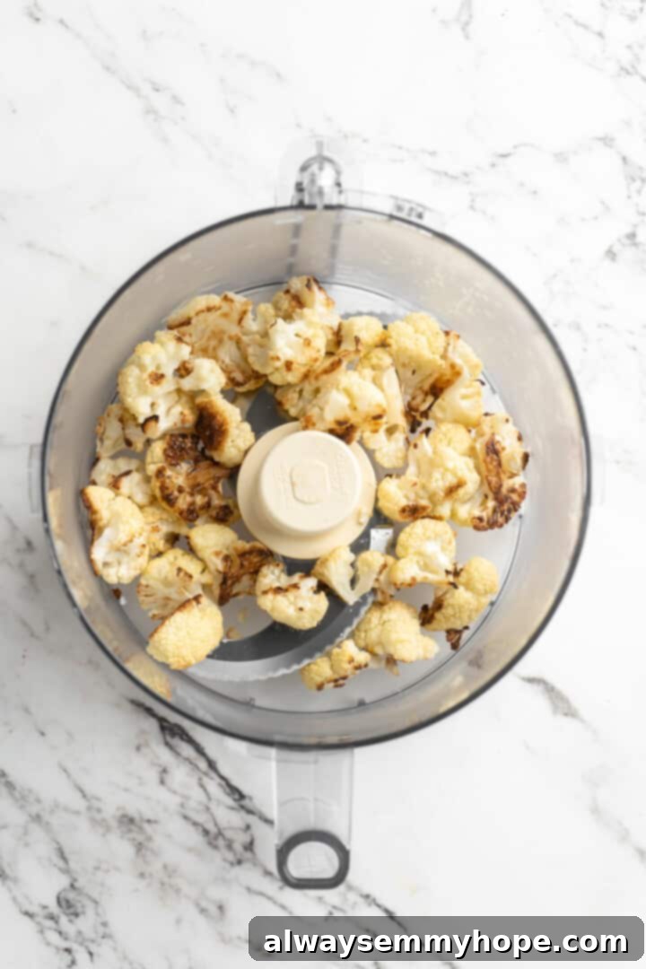 Overhead view of cauliflower in food processor