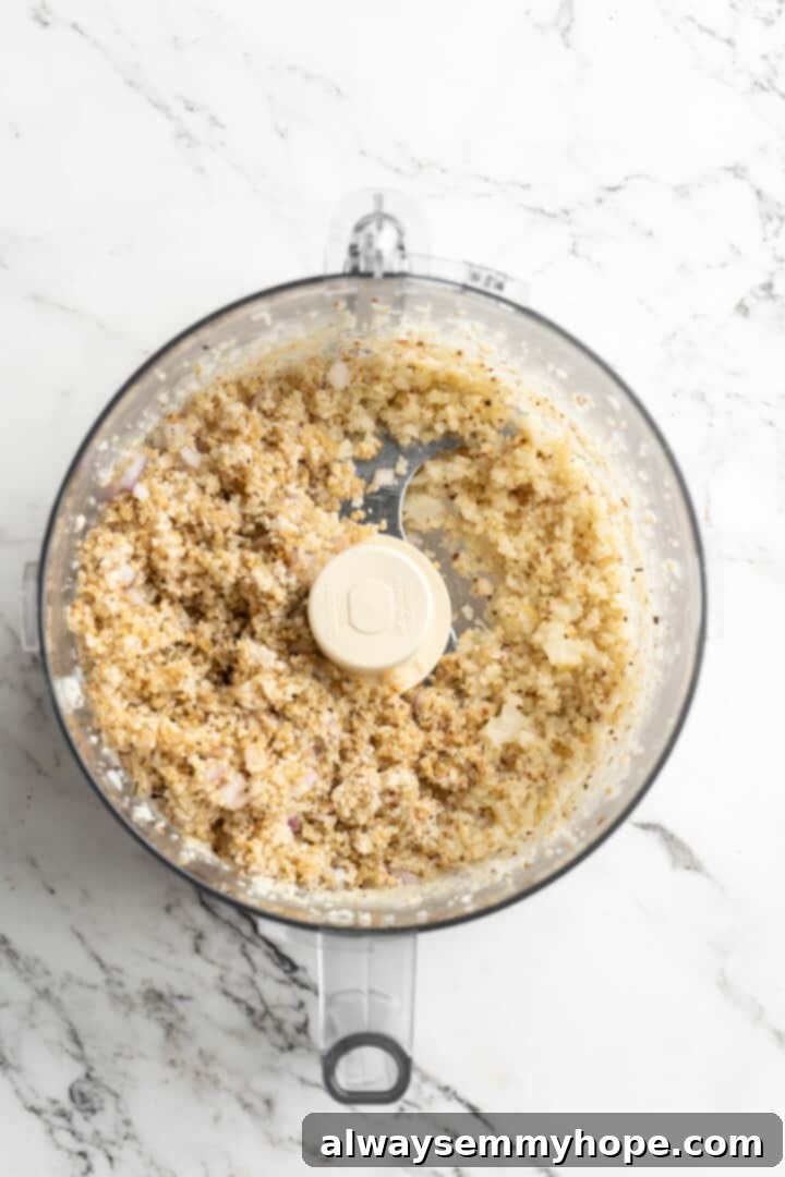 Overhead view of riced cauliflower in food processor with quinoa