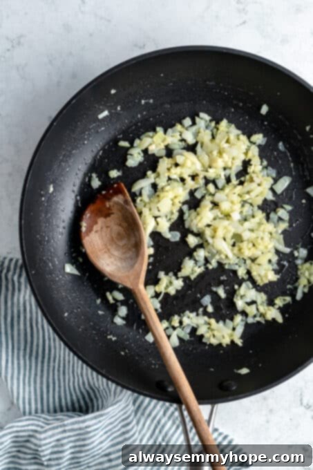 Sautéed onion and garlic in a pan.