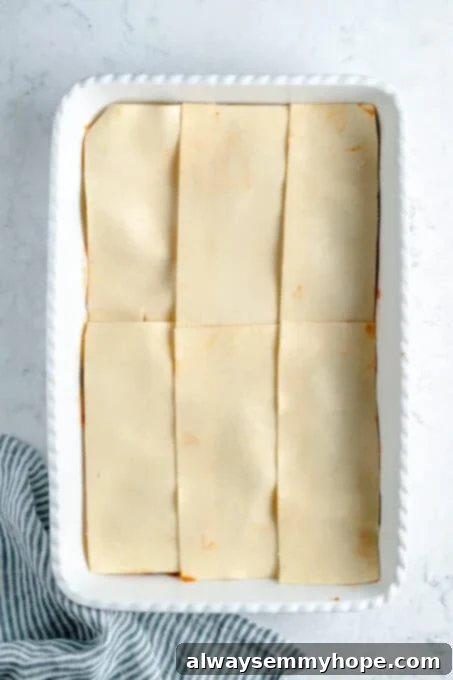 A layer of lasagna noodles in a baking dish.