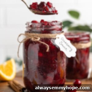Spoonful of cranberry orange sauce held over jar