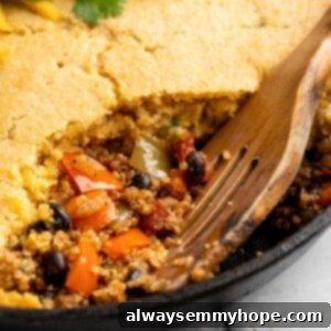 Hearty Chili Cornbread Bake 2 Chili cornbread casserole in pan with wooden spoon, ready to be served