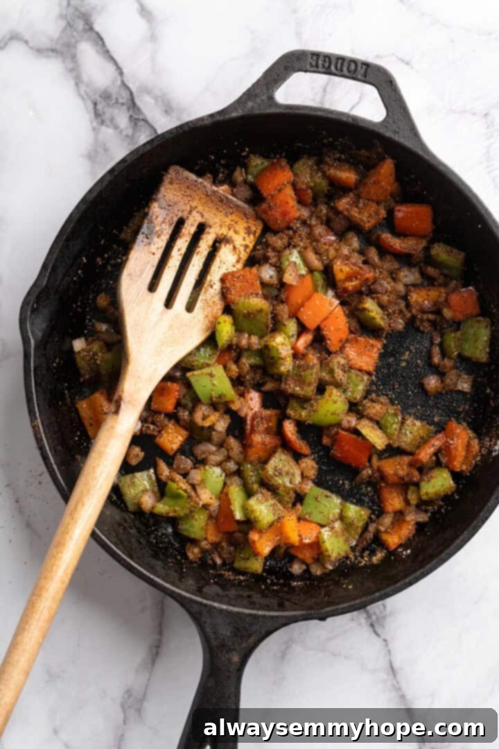 This vegan chili cornbread casserole is one of the BEST casseroles ever! The secret? Sweet, crispy cornbread baked on top of delicious chili. Vegetables and seasonings cooking together in a skillet, creating a fragrant chili base