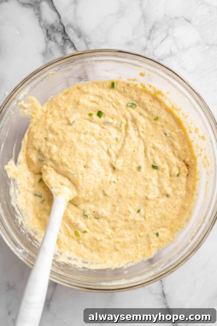 This vegan chili cornbread casserole is one of the BEST casseroles ever! The secret? Sweet, crispy cornbread baked on top of delicious chili. Cornbread topping batter in a mixing bowl, smooth and ready to be spread over the chili