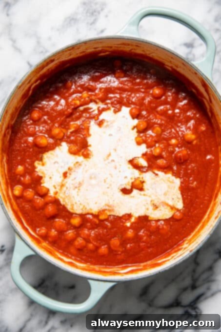 Coconut milk mixed in with chickpeas and tomato sauce.