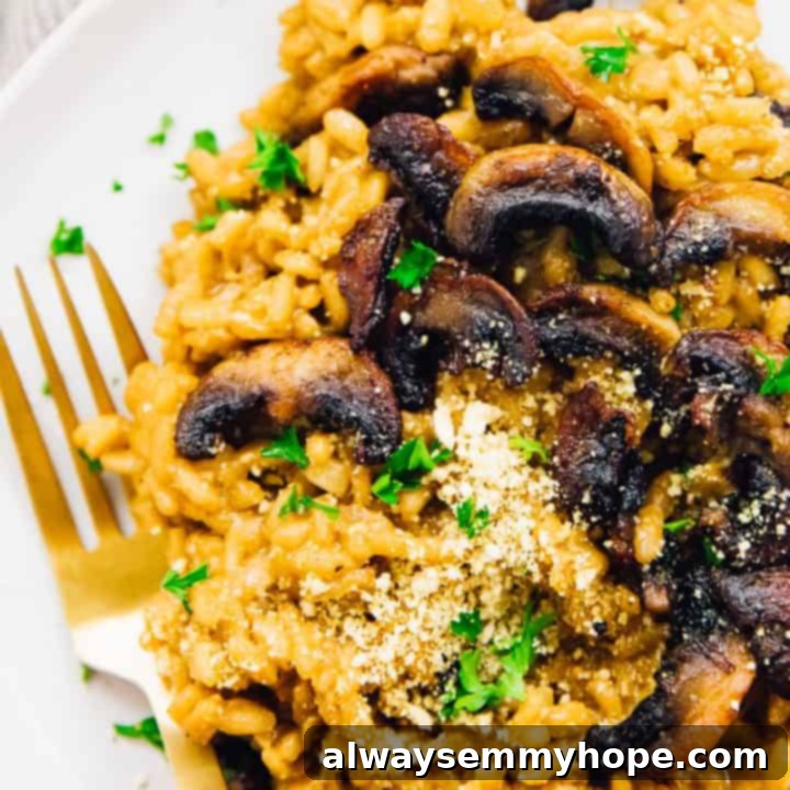 80+ Vegan Thanksgiving Feast Recipes 18 A steaming bowl of creamy vegan mushroom risotto, garnished with fresh parsley and showcasing rich, caramelized mushrooms.
