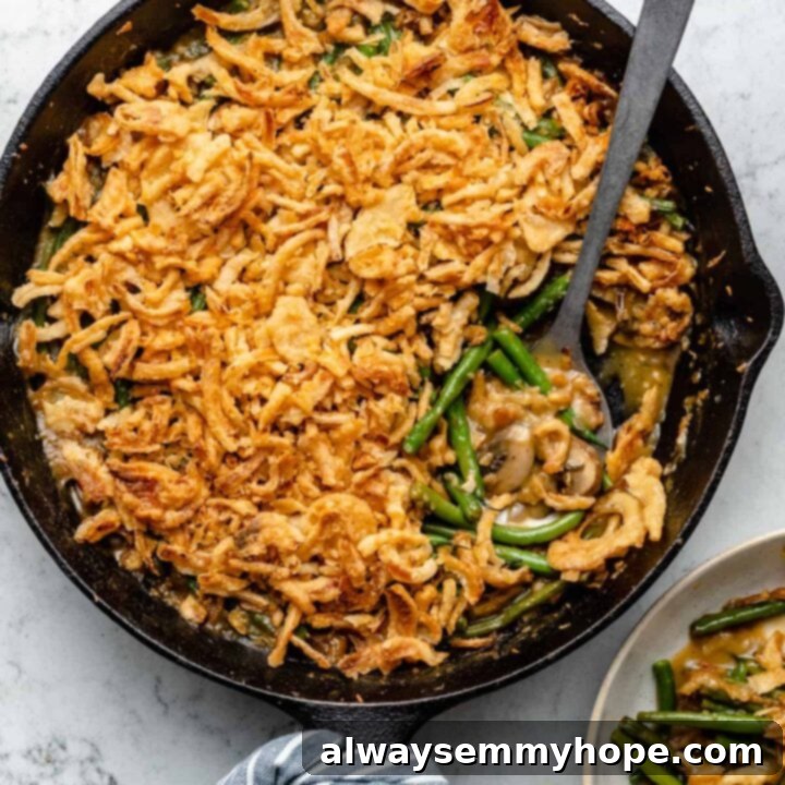80+ Vegan Thanksgiving Feast Recipes 38 A bubbly, golden vegan green bean casserole, topped with crispy fried onions, ready to serve.