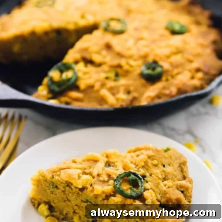 80+ Vegan Thanksgiving Feast Recipes 48 A golden-brown vegan cheesy cornbread skillet, bubbling with melted cheese and ready to serve.