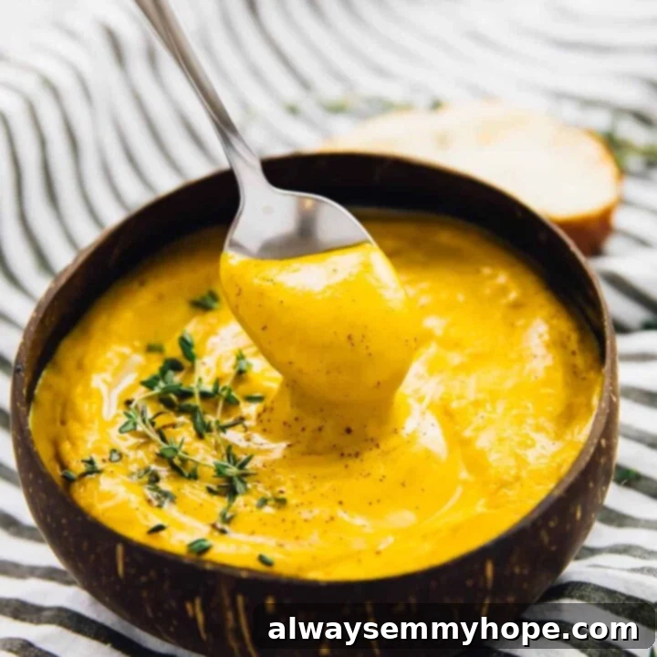 80+ Vegan Thanksgiving Feast Recipes 49 A rich and creamy roasted sweet potato soup, garnished with fresh herbs and a swirl of cream, served in a rustic bowl.