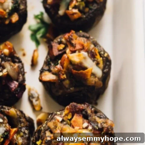 80+ Vegan Thanksgiving Feast Recipes 53 Savory vegan stuffed mushrooms topped with crispy coconut bacon, perfect as an appetizer or side dish.