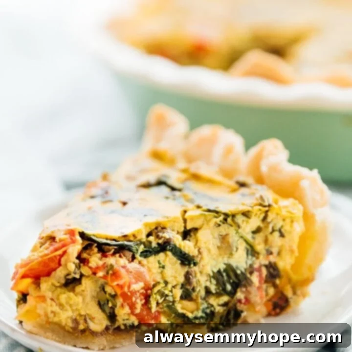 80+ Vegan Thanksgiving Feast Recipes 8 A savory, golden-baked easy vegan quiche with a rich tofu filling, visible tomatoes, and spinach, presented on a rustic board.
