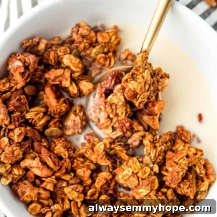 80+ Vegan Thanksgiving Feast Recipes 9 A bowl of healthy pumpkin granola with large clusters, dried fruit, and nuts, perfect for a cozy fall breakfast.