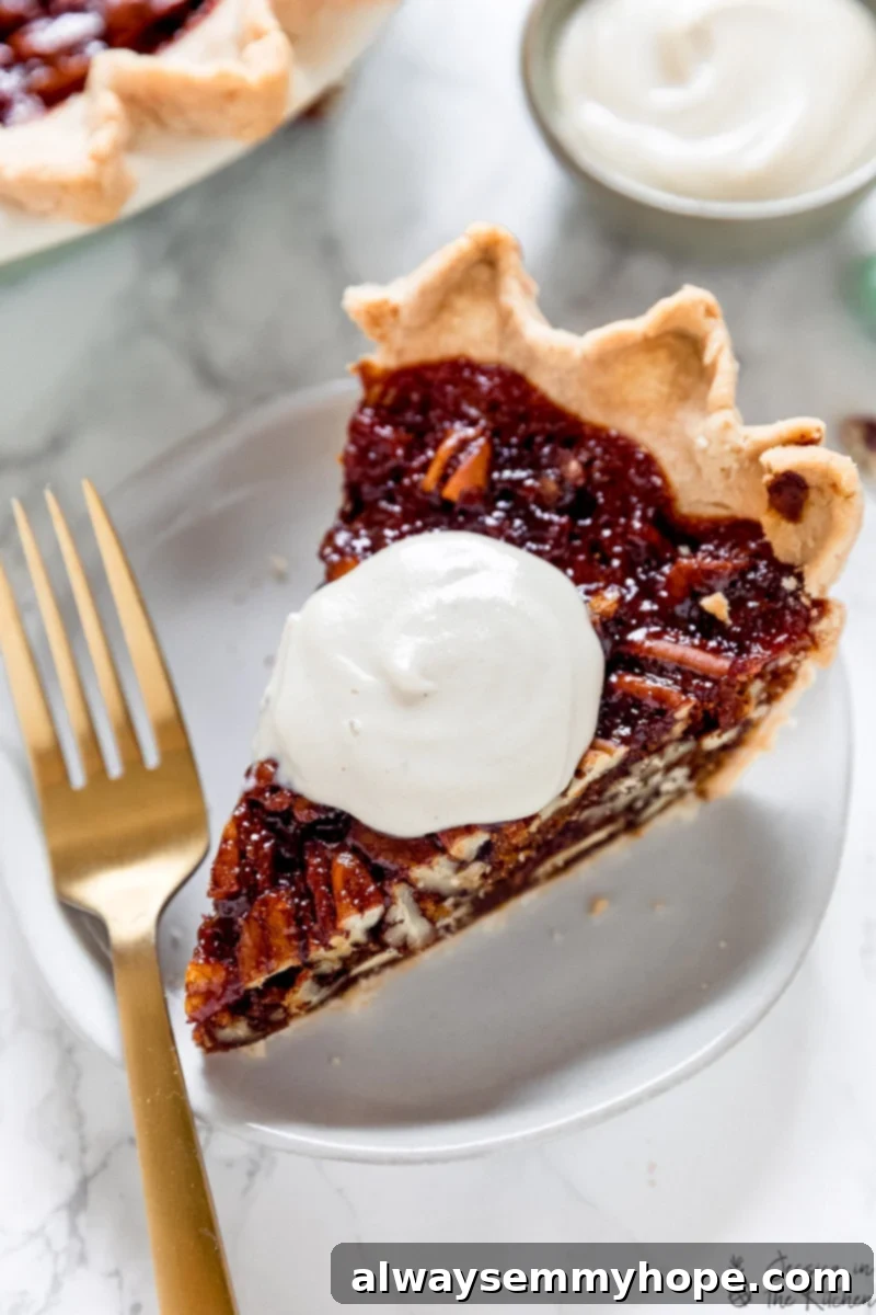 Vegan Cashew Whipped Cream 3 A generous dollop of cashew whipped cream on a golden slice of vegan pecan pie.