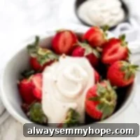 Vegan Cashew Whipped Cream 5 Cashew whipped cream on a bowl of fresh strawberries.