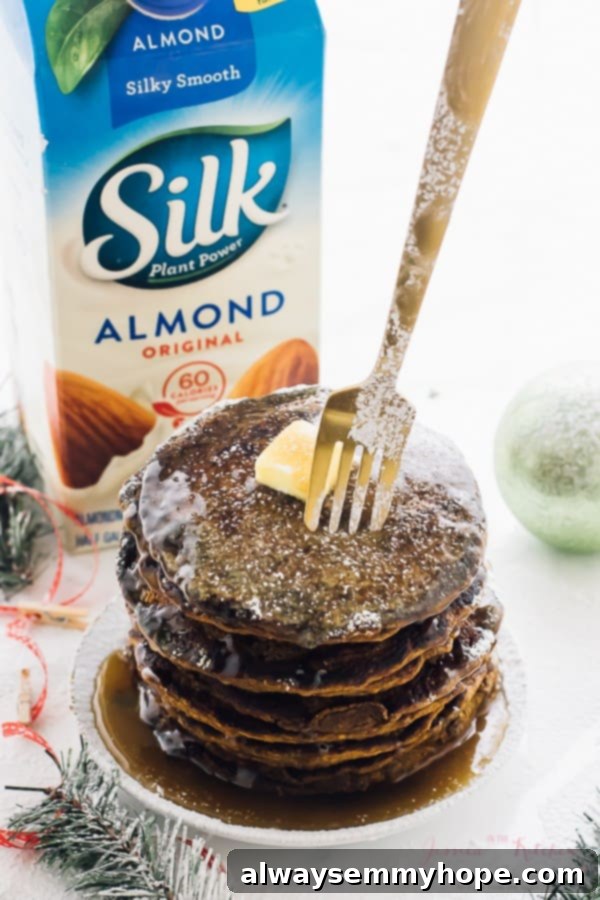Stack of gingerbread pancakes drizzled with syrup.