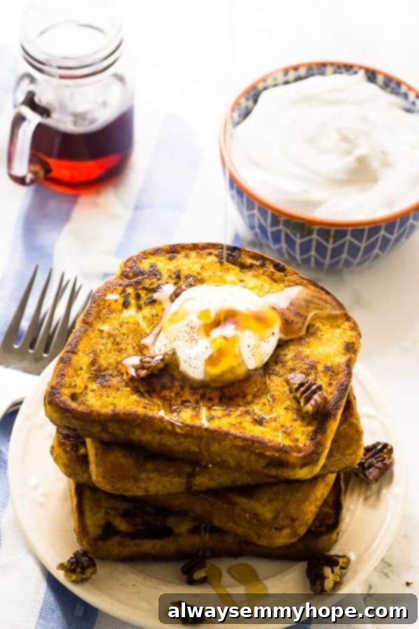 Vegan pumpkin French toast slices topped with powdered sugar.