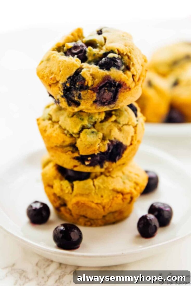 Fluffy vegan blueberry muffins, some with a sprinkle of sugar.