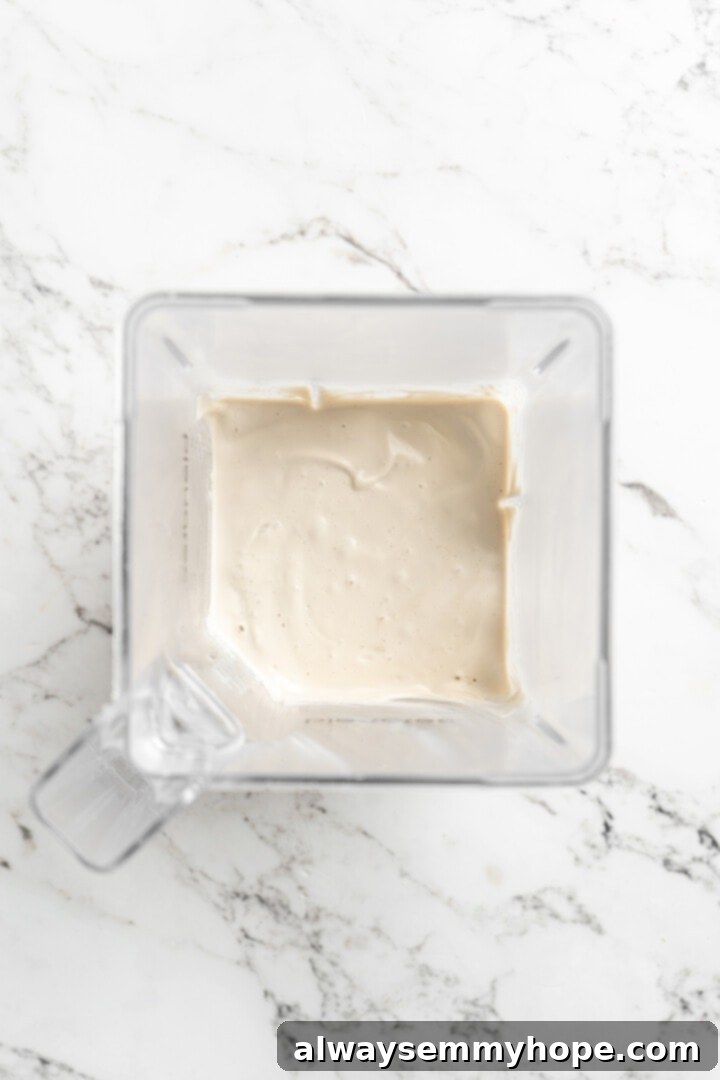 This vegan sour cream recipe is thick, creamy and tangy—and you only need 5 ingredients! Use it all the ways you use traditional sour cream. Overhead view of vegan sour cream in blender