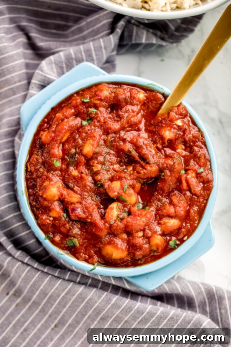 Overhead view of tomato sauce in a blue pot, glistening and rich.