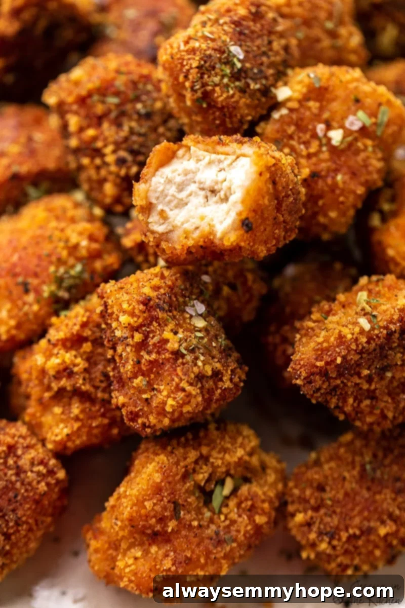 Crispy Crunchy Vegan Chicken Nuggets 2 Vegan chicken nuggets with a bite taken out of it.