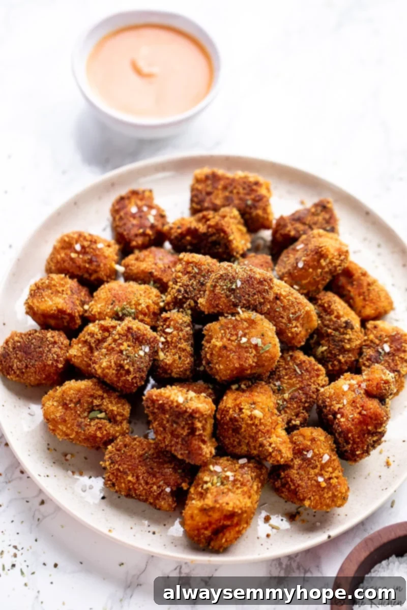 Crispy Crunchy Vegan Chicken Nuggets 3 Vegan chicken nuggets made with tofu on a plate.