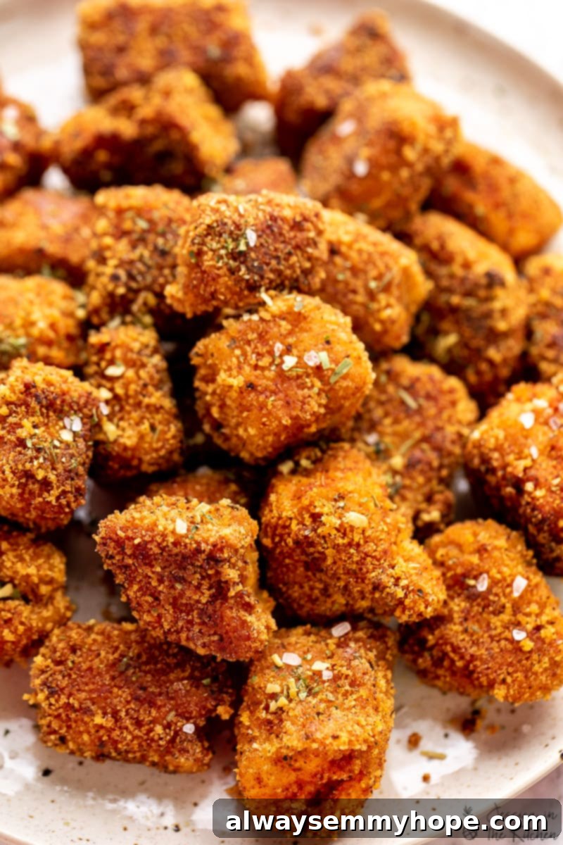 Crispy Crunchy Vegan Chicken Nuggets 4 Vegan chicken nuggets on a plate, close up.