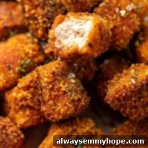 Crispy Crunchy Vegan Chicken Nuggets 6 Closeup of vegan tofu nuggets, one with a bite taken out.