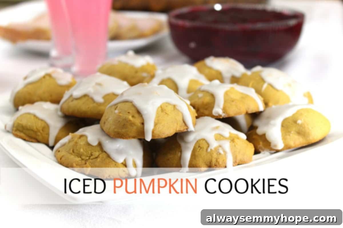 A batch of perfectly baked, soft and chewy Iced Pumpkin Cookies on a white dish, ready to be devoured.