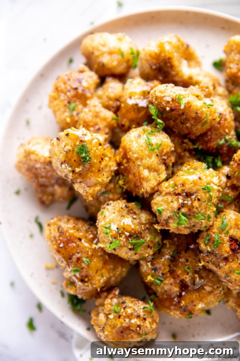 Top down view of lemon pepper cauliflower wings on a plate. 