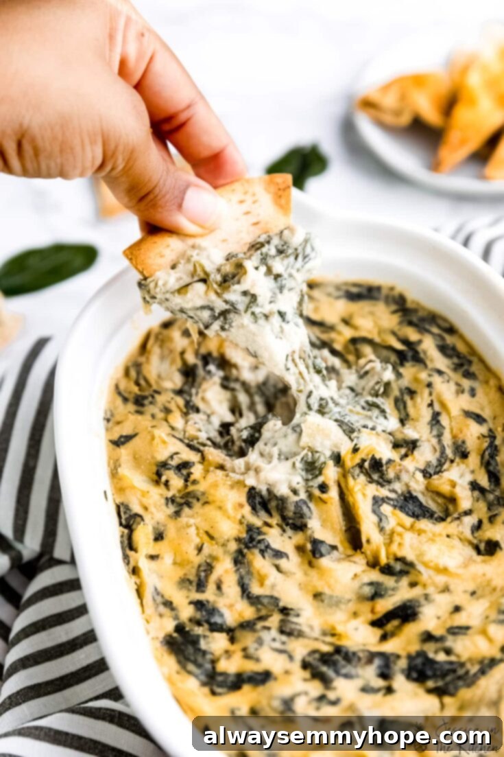 Score Big with 30 Vegan Super Bowl Recipes 5 Creamy Vegan Spinach Artichoke Dip with tortilla chips.
