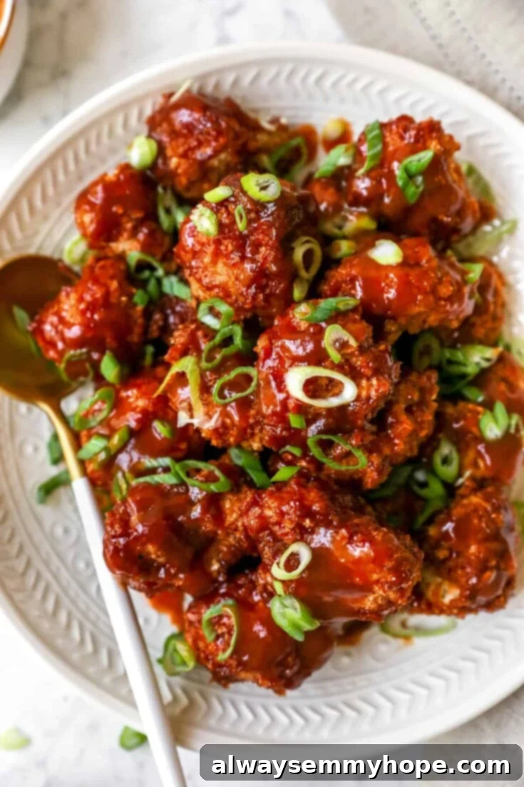 Score Big with 30 Vegan Super Bowl Recipes 7 Sticky BBQ Cauliflower Wings on a plate, garnished with sesame seeds.