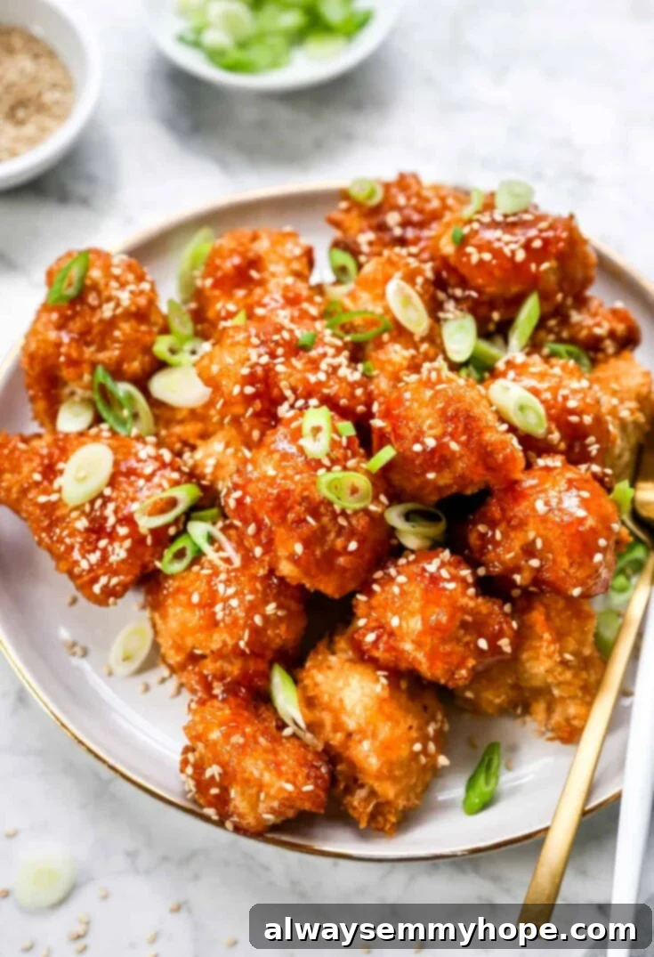 Score Big with 30 Vegan Super Bowl Recipes 9 Sweet and Sour Cauliflower Wings in a bowl with a colorful glaze.