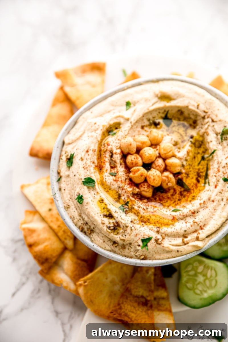 The Ultimate Homemade Hummus 4 Bowl filled with homemade hummus, topped with olive oil, za'atar, and chickpeas