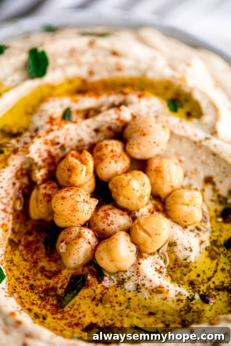 The Ultimate Homemade Hummus 5 Close up of chickpeas on hummus flecked with za'atar and paprika