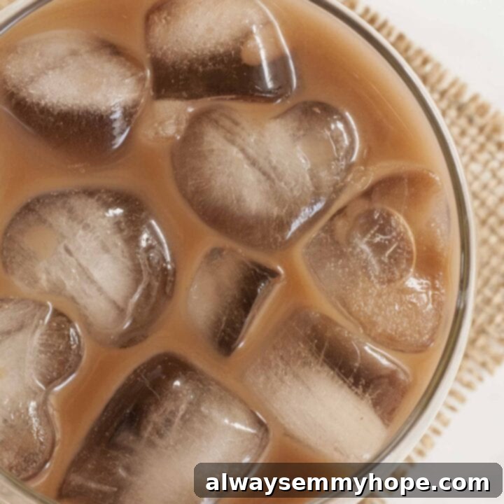 25 Festive Vegan Recipes for St. Patrick's Day 22 Homemade Vegan Baileys made with almond milk in a glass, with ice.