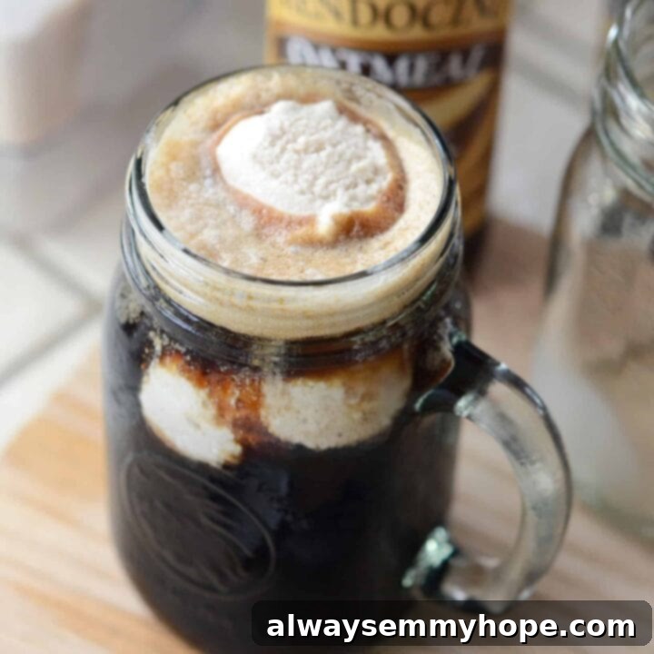 25 Festive Vegan Recipes for St. Patrick's Day 27 Irish Whiskey Ice Cream Beer Float in a tall glass, with foam and a straw.