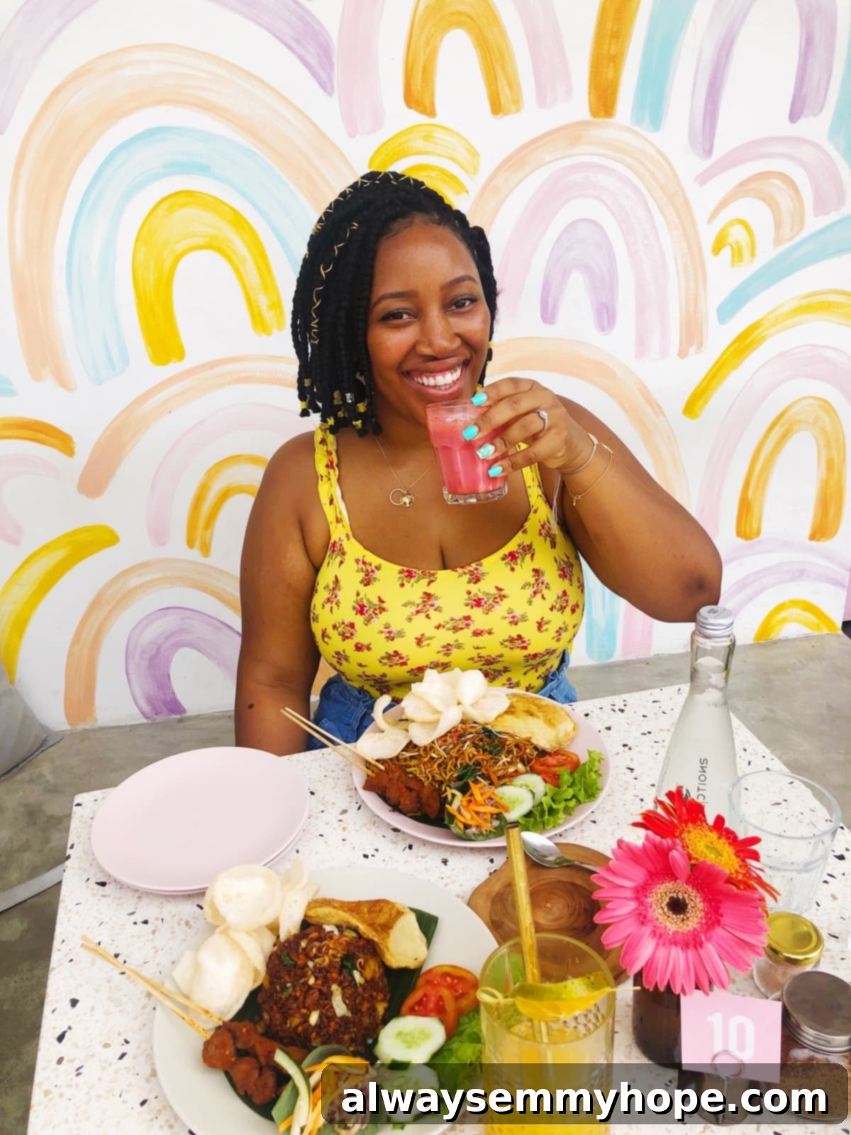 Jessica sat at a table with plates of food.