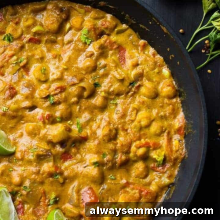 Creamy Vegan Coconut Chickpea Curry in a bowl, garnished with fresh herbs, ready to serve.