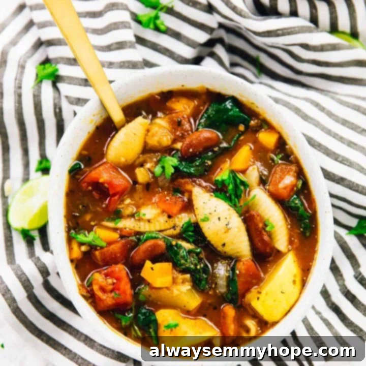 Hearty Minestrone Soup in a bowl with crusty bread, featuring pasta, beans, and vegetables.