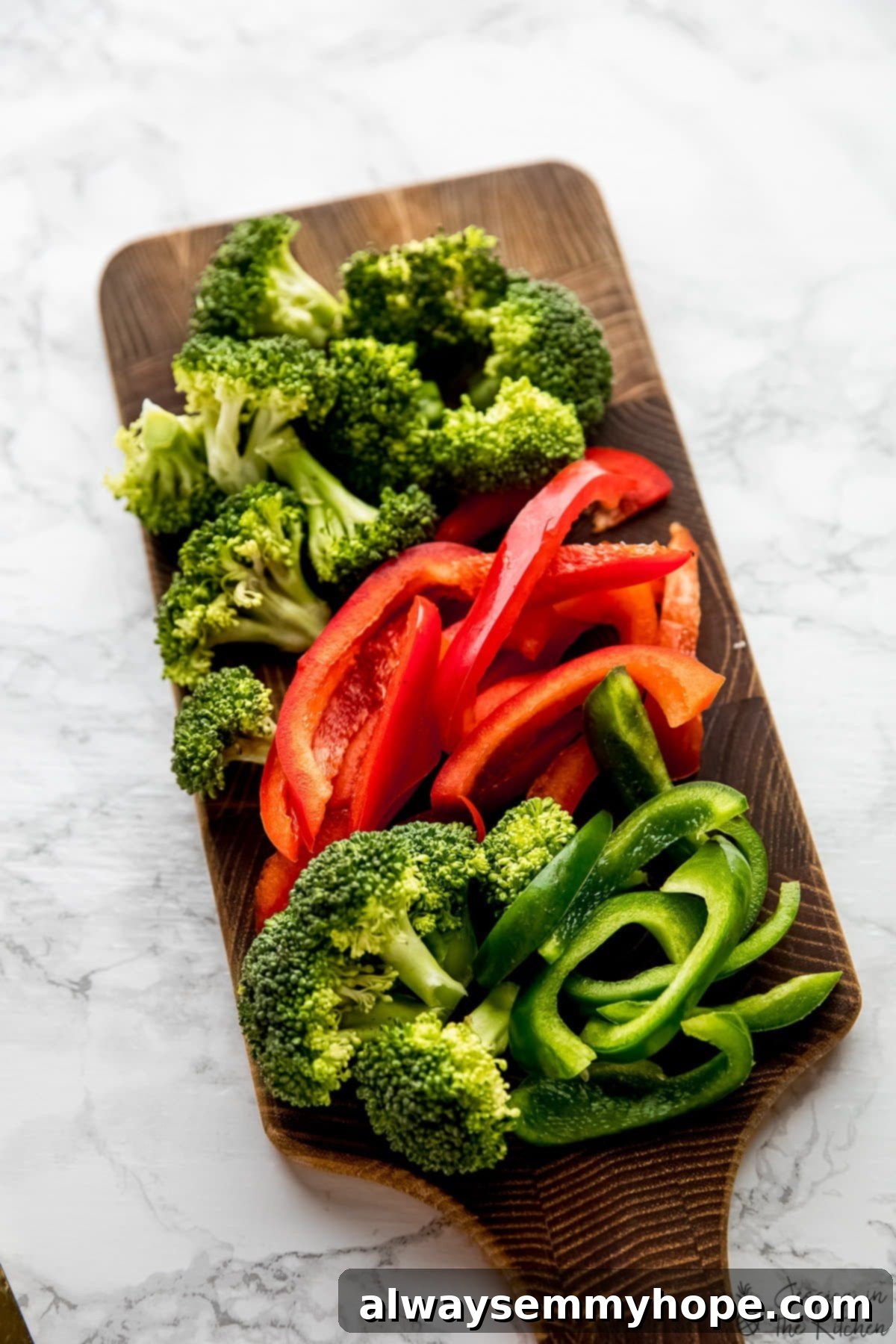 chopped broccoli and bell peppers on a cutting board