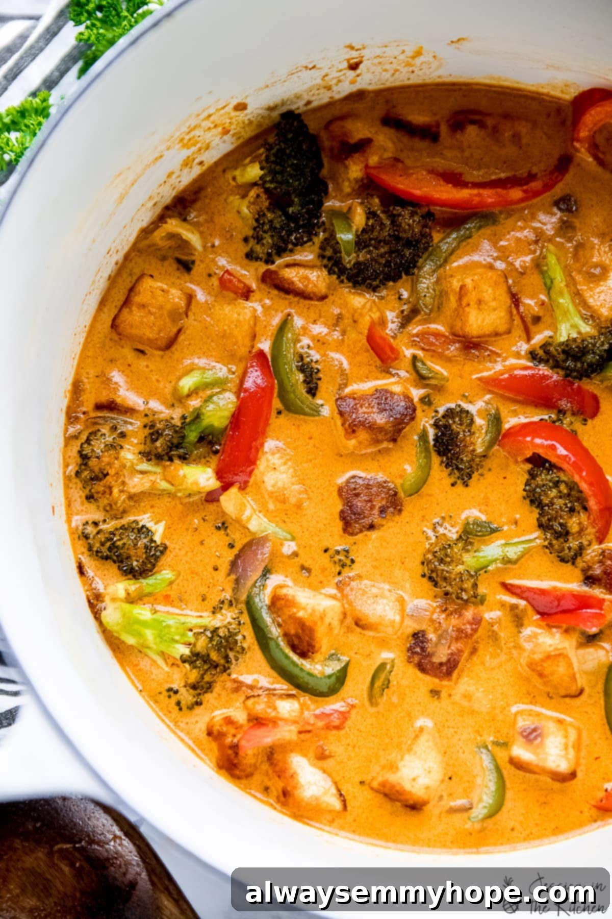 Overhead view of vegan Thai red curry in white Dutch oven