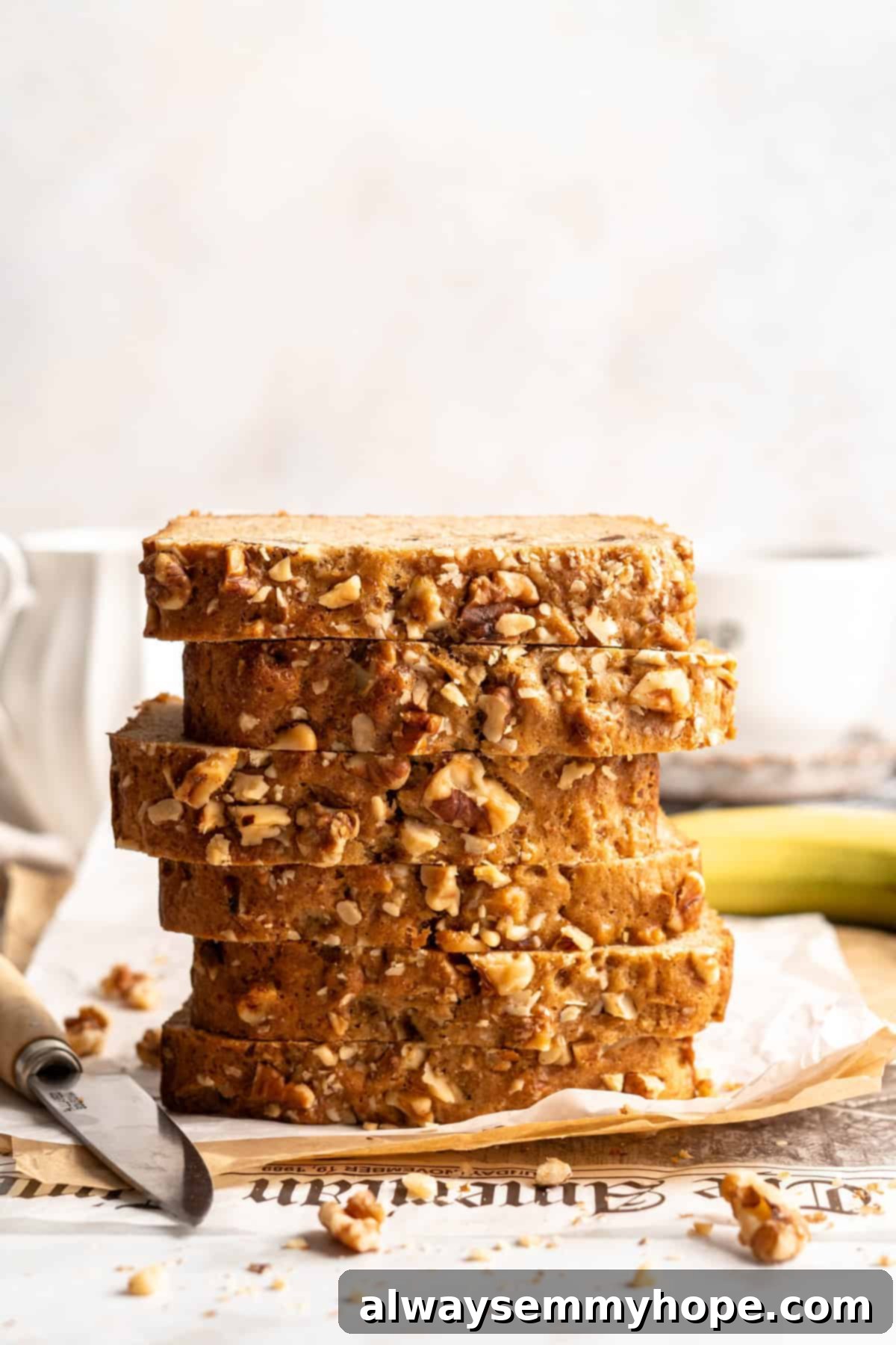 Stacked slices of banana bread set on parchment paper