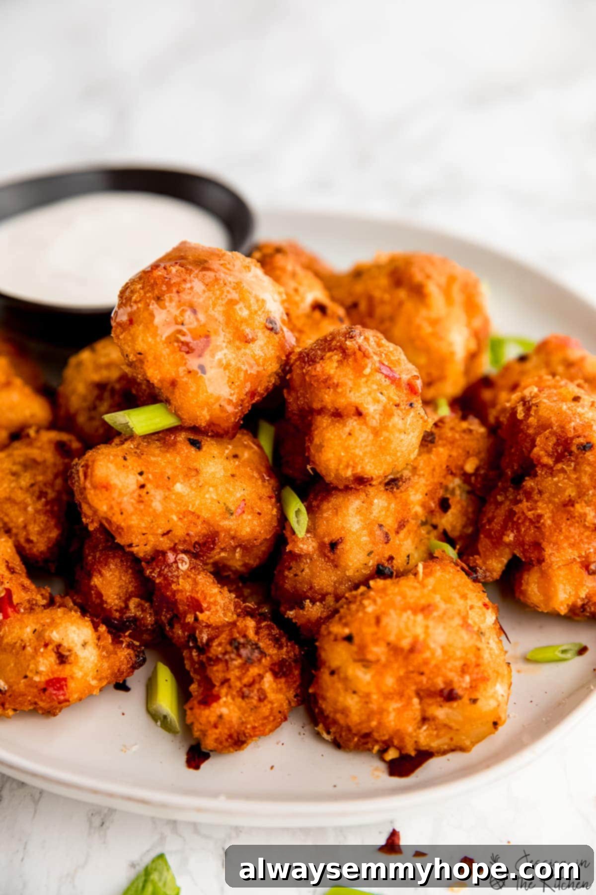 Close up of bang bang cauliflower wings on a plate, ready to be enjoyed.