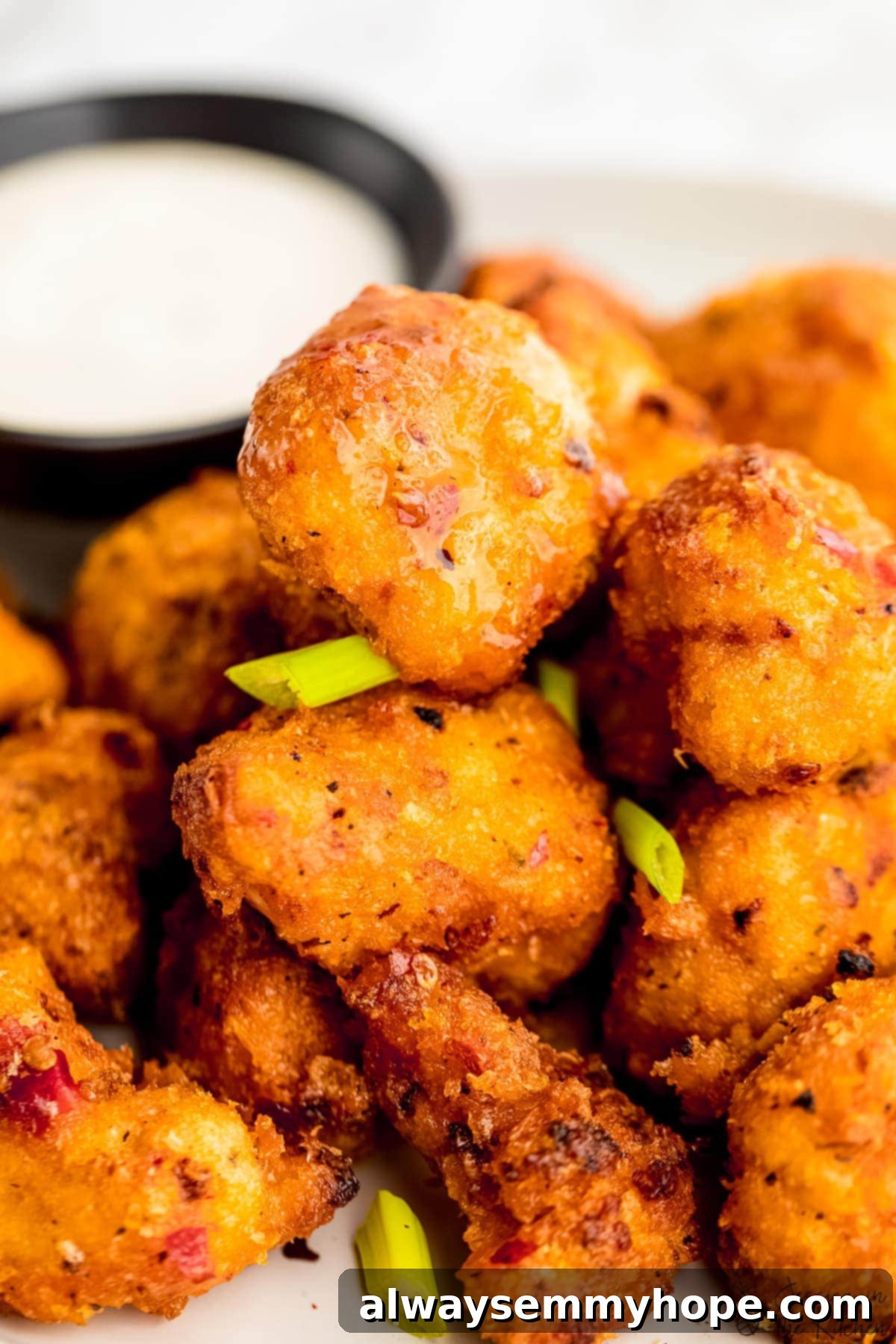 Bang bang cauliflower in a closeup view, showing the crispy texture and vibrant sauce.