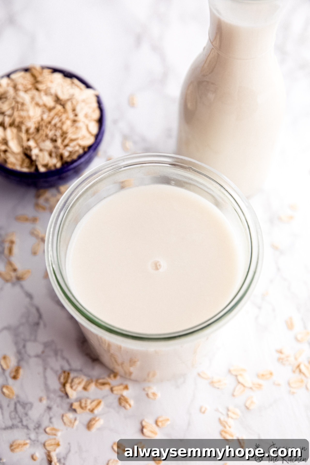 Enjoy the rich, creamy, and delicious taste of homemade oat milk, made easy with this recipe and beautifully presented in a glass jar. A charming close-up of homemade oat milk in a glass weck jar, viewed from above, highlighting its smooth and inviting texture.