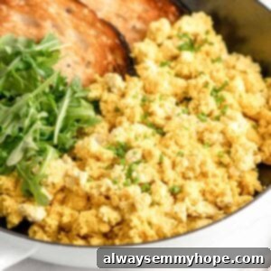 Tofu scrambled eggs with browned toast in a pan.