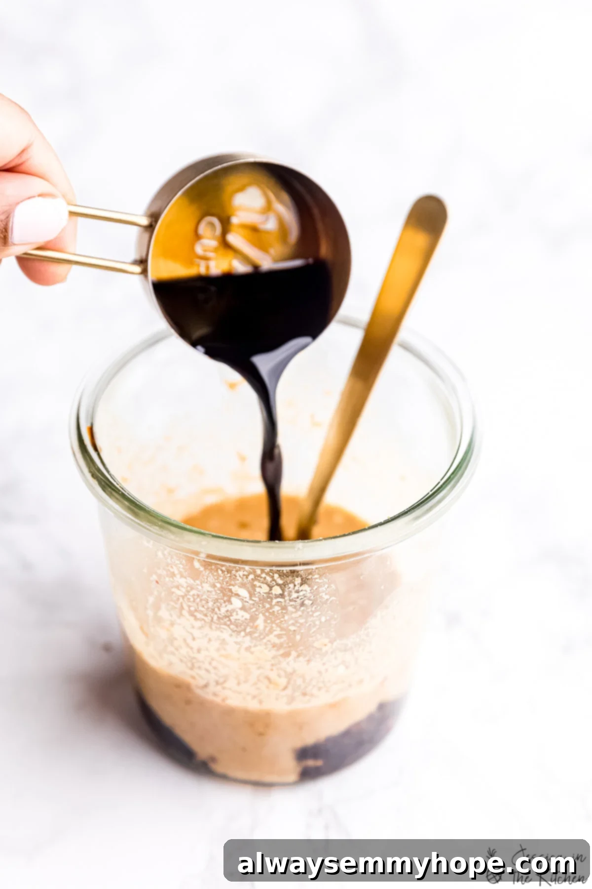 Creamy Thai Peanut Sauce 3 Soy sauce being poured into a jar to make Thai peanut sauce.